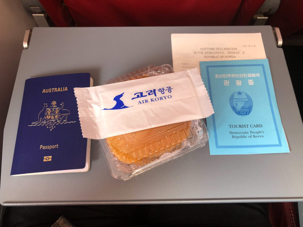 North Korea tourist card and Air Koryo burger on the flight to Pyongyang